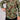 Camo quarter-zip pullover with a front kangaroo pocket and a hand accessing a concealed firearm.