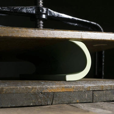 Green 3.5x5 Rite in the Rain soft cover book with curved pages under a vintage press.