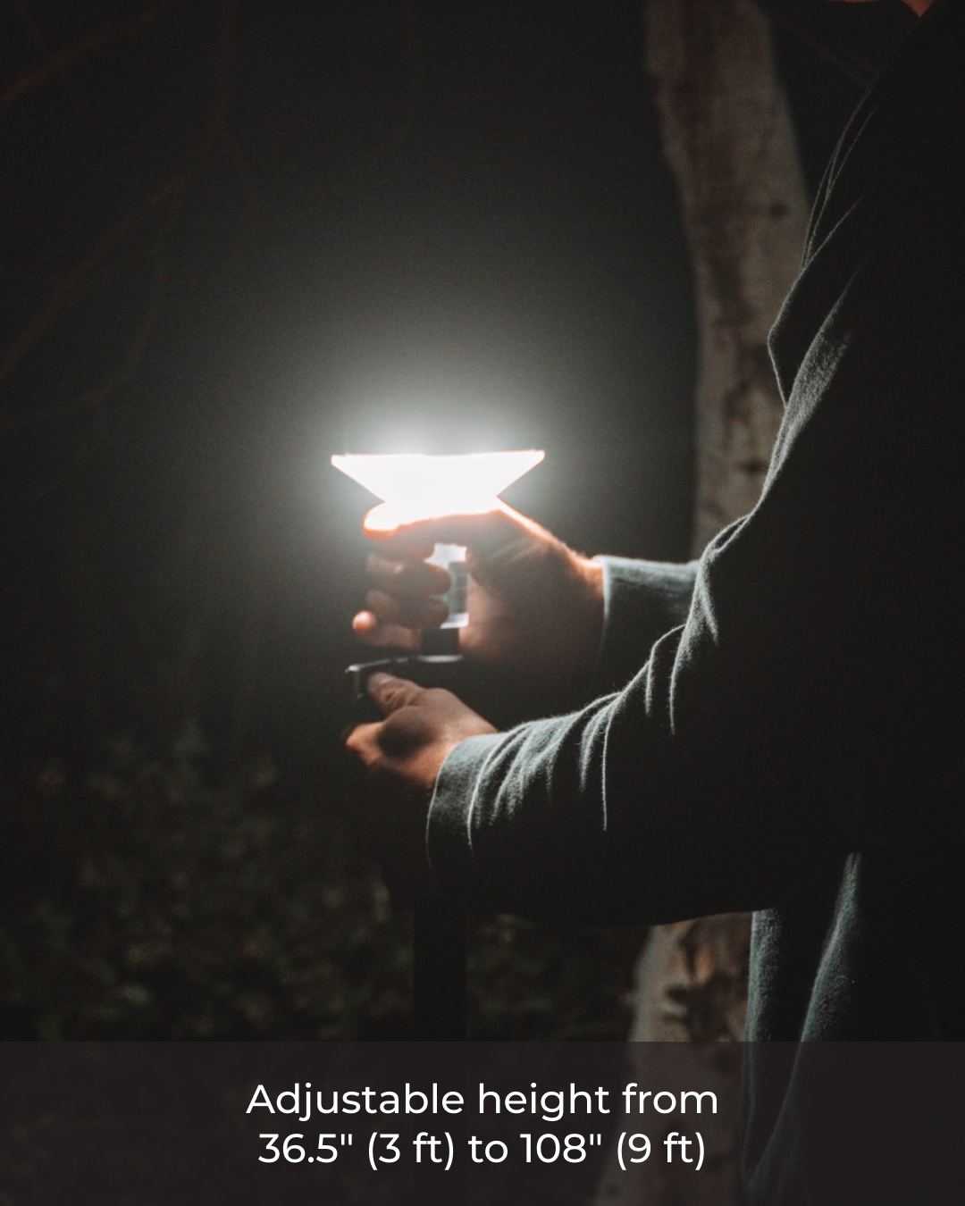 Person adjusting a bright Devos LightRanger 1200, a portable, telescoping light with a white diffuser.