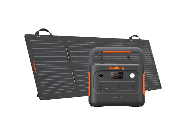 Jackery Explorer 1000 v2 power station in dark gray with orange accents, next to a folded black solar panel.