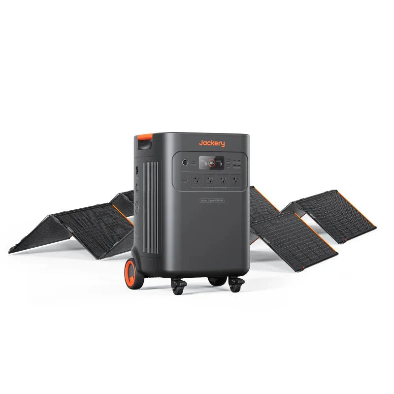 Jackery Explorer 5000 Plus portable power station in dark gray with orange accents, on wheels, surrounded by black solar panels.