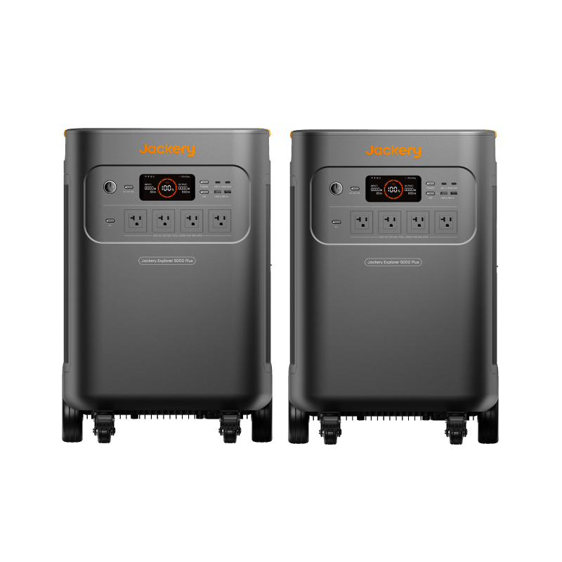 Two dark gray Jackery Explorer 5000 Plus portable power stations with orange accents and wheels.
