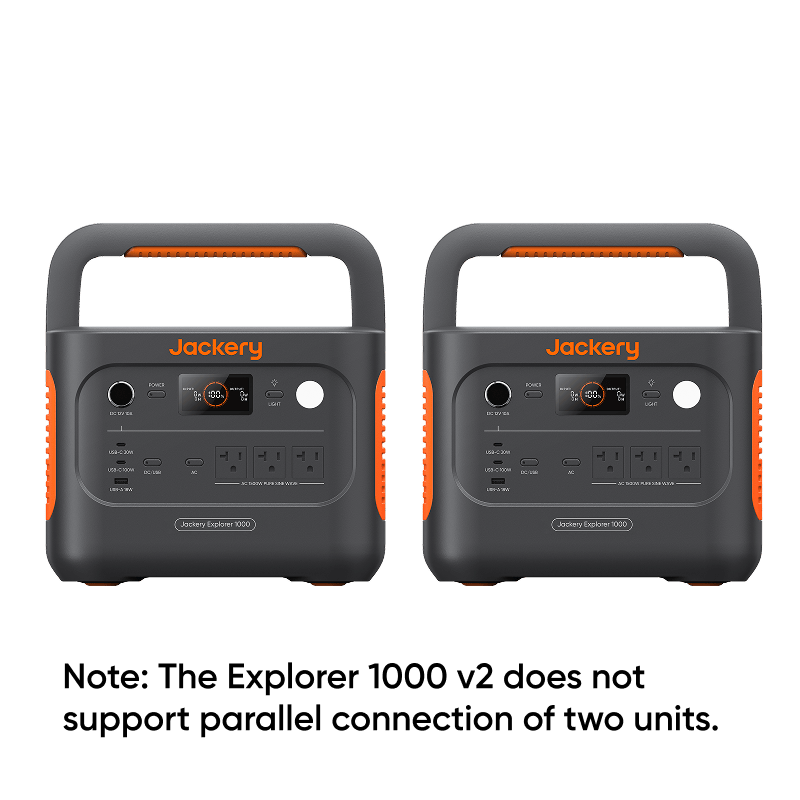 Two Jackery Explorer 1000 v2 portable power stations, dark gray with orange accents and handles, displaying 100% charge.