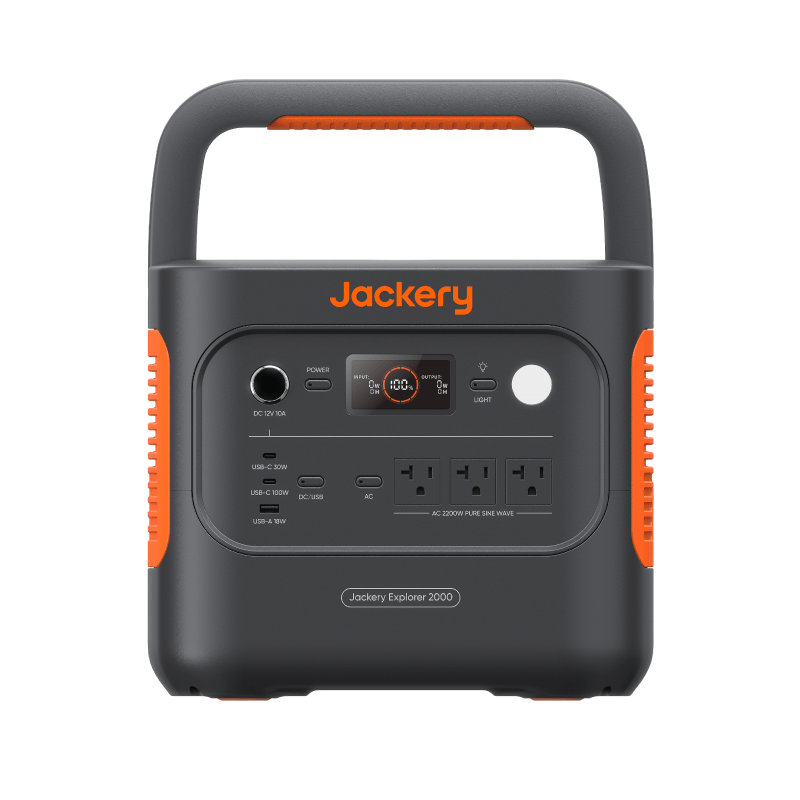 Jackery Explorer 2000 portable solar generator in dark gray with orange accents, featuring multiple power outlets and a digital display.