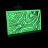 Maratac 3x2 inch glow-in-the-dark silicone patch with black topographic map lines.