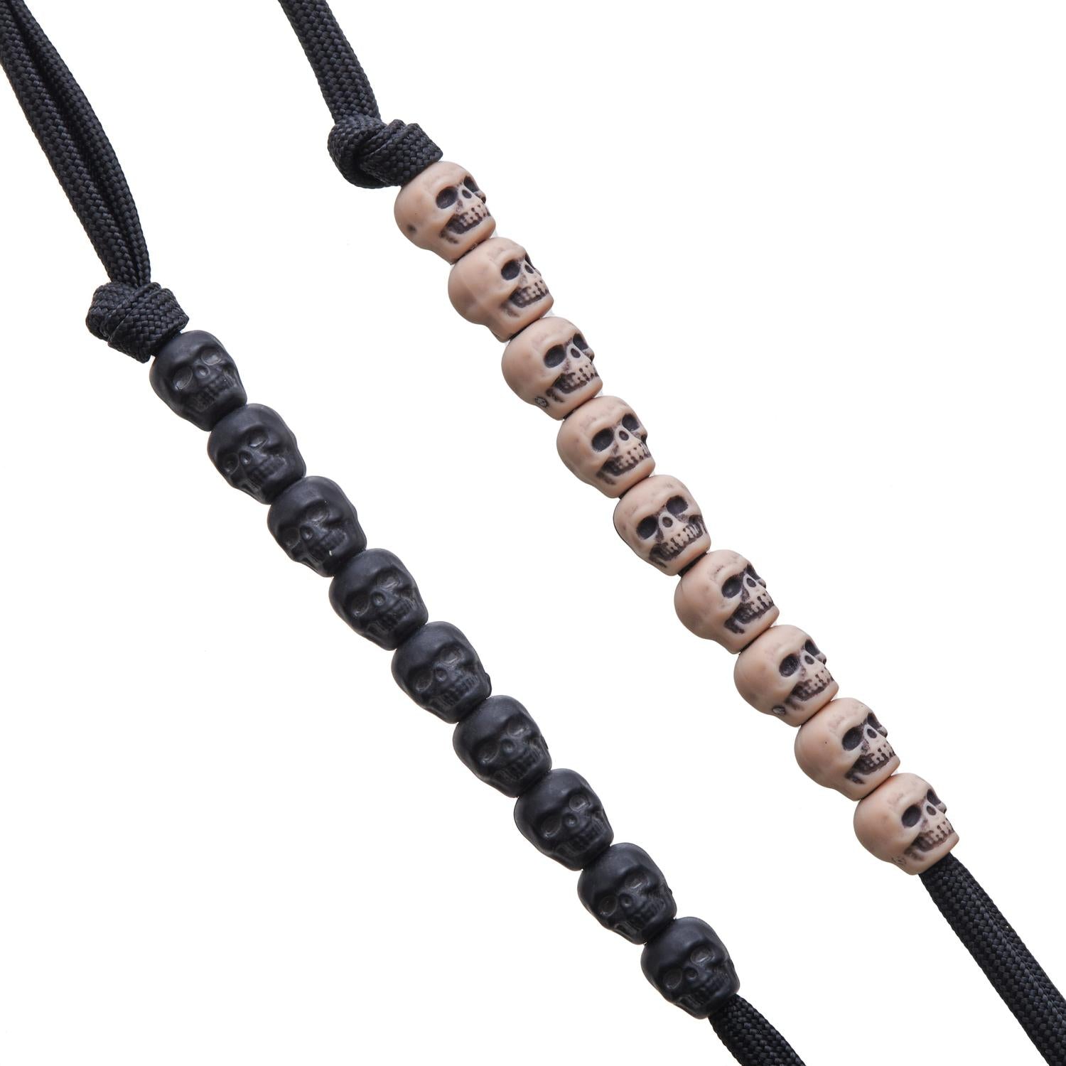 Two black paracord pace counters with skull beads: one with black skulls, the other with tan skulls.