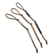 Three LYNX Survival Systems pace counter beads with tan paracord, featuring white, light wood, and dark gray beads.