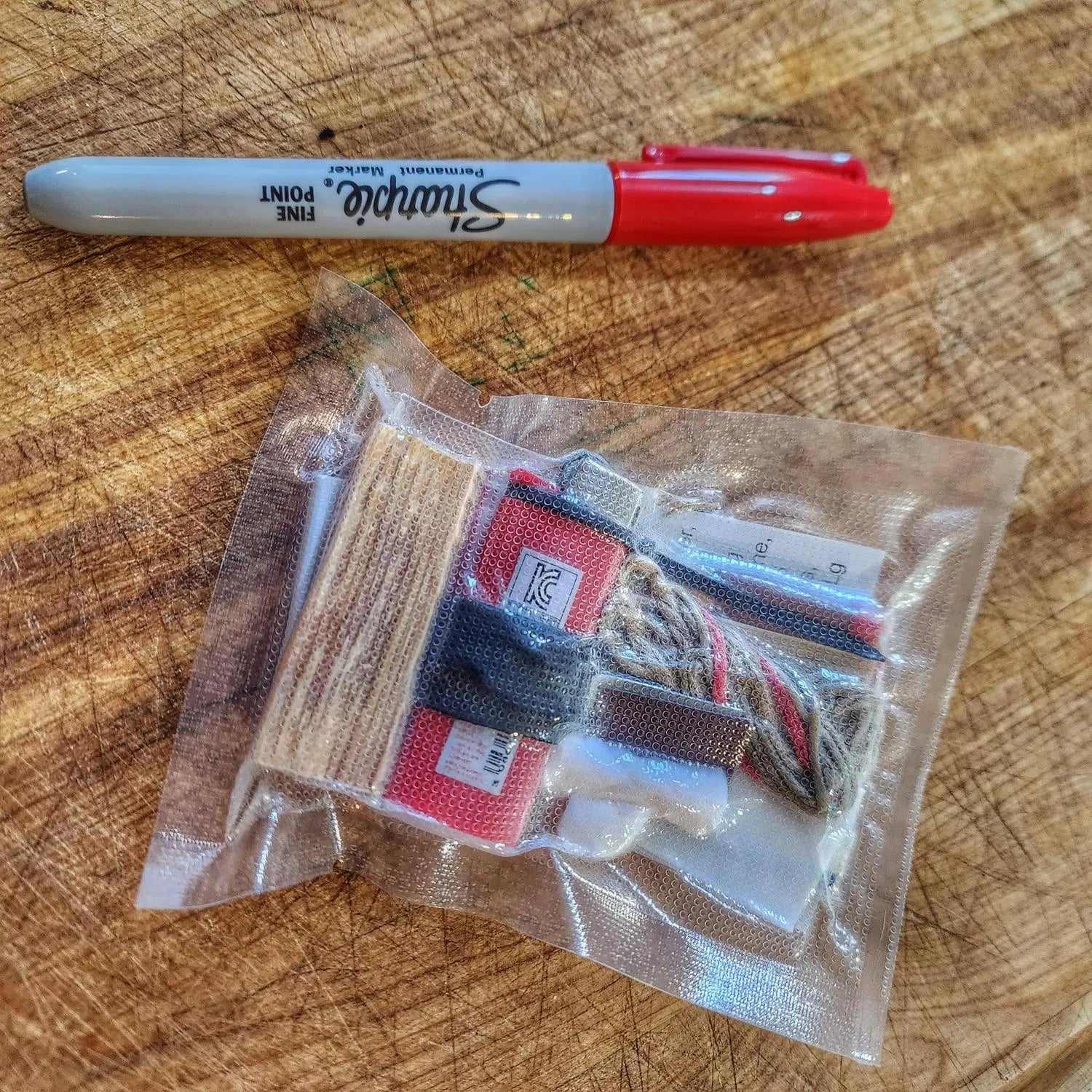 Survival Kit Lighter - Fire Starter outfitted with supplies.