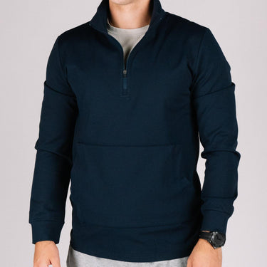 Dark blue quarter-zip pullover with a front pass-through pocket, worn by a man.