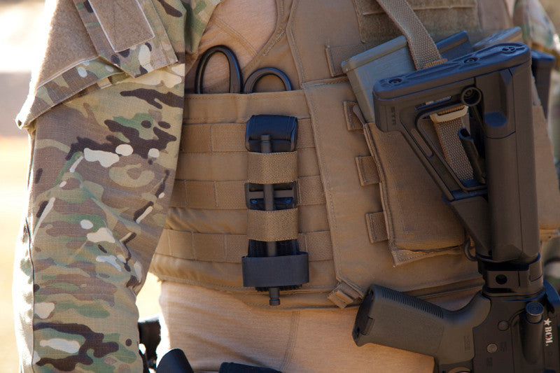 Tourniquet NOW! Strap mounted on the side of a plate carrier