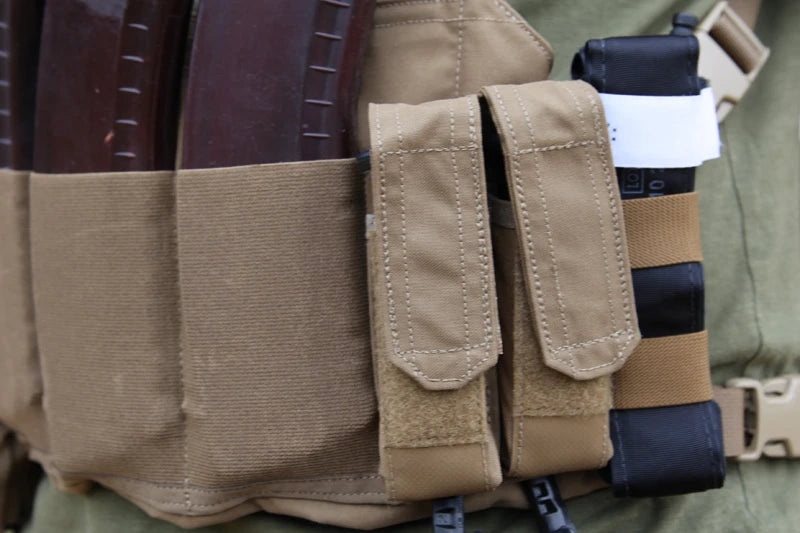 Close up of the Tourniquet NOW! Strap holding a tourniquet on a chest rig